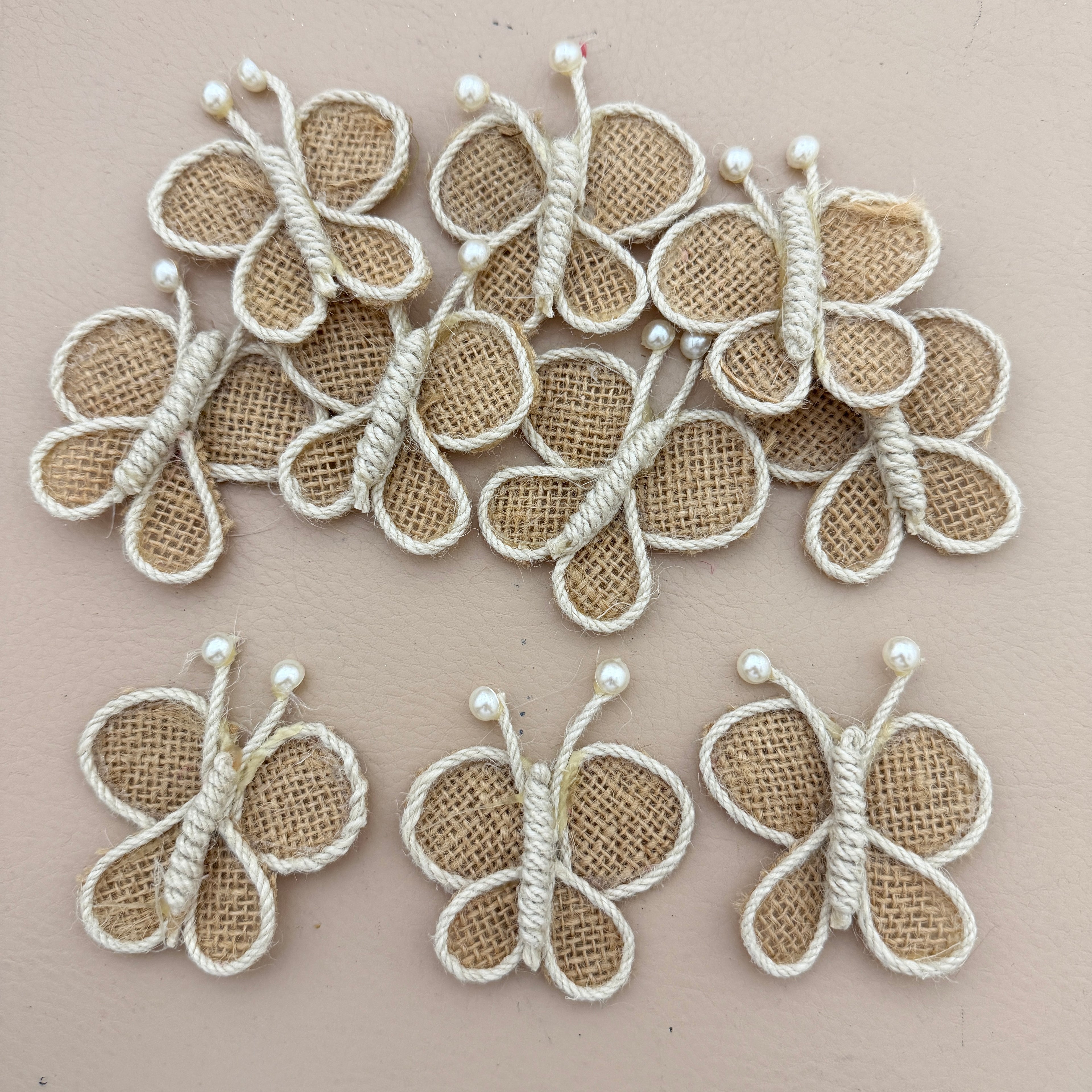 Pack of 5 Handmade Jute Burlap Butterfly Patches on beige background