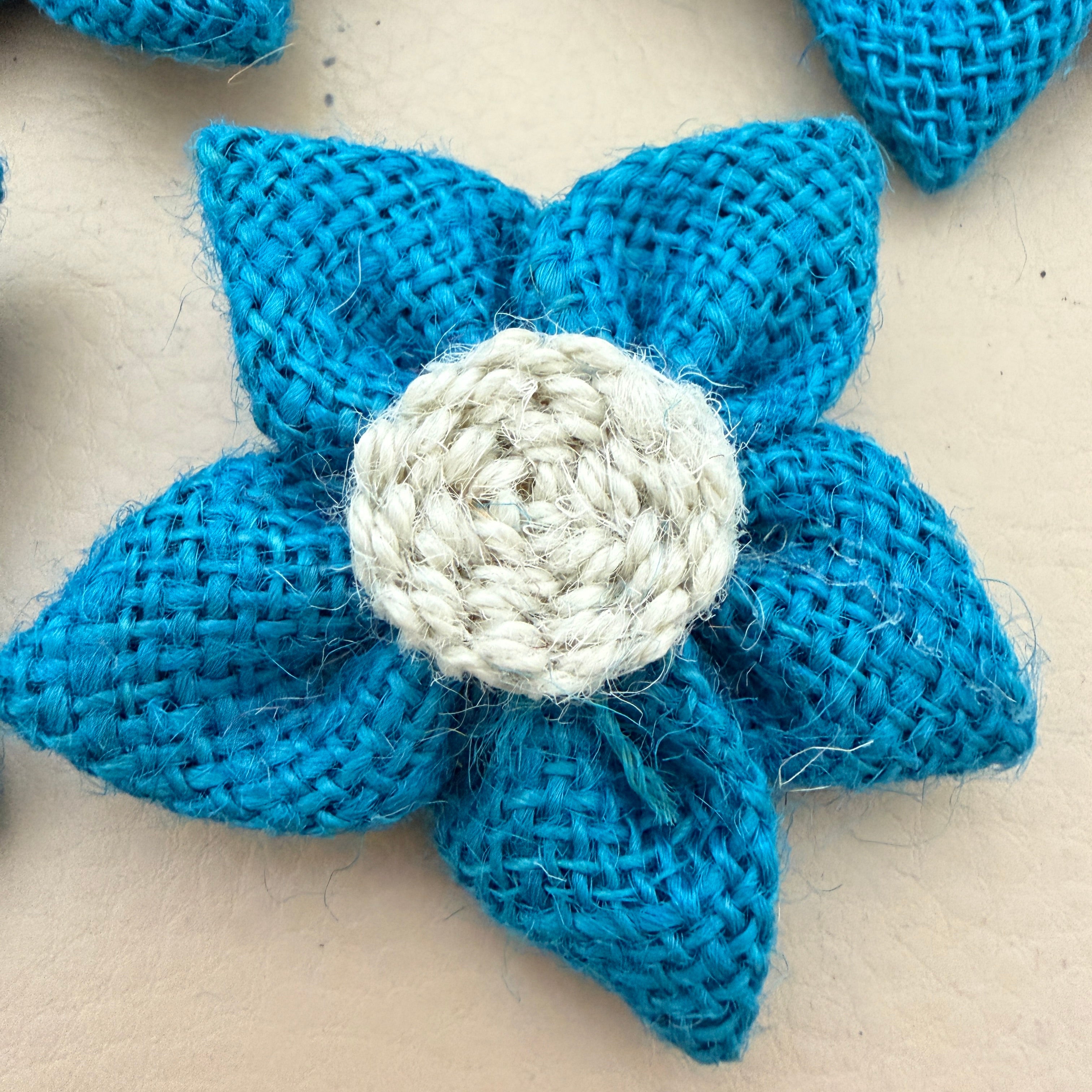 Close-up of blue jute burlap flower patch showing rope spiral centre detail