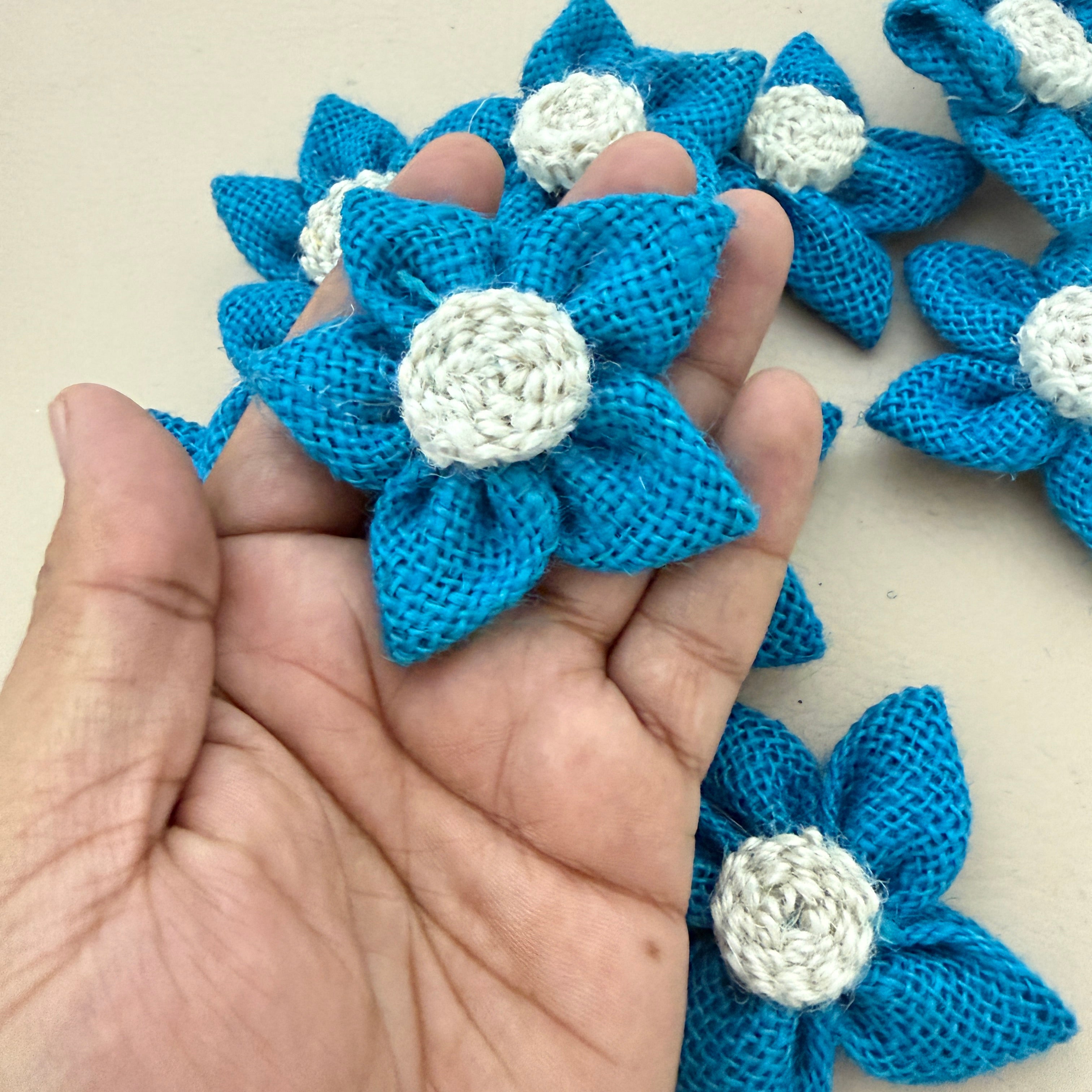 Blue jute burlap flower patch held in hand showing size