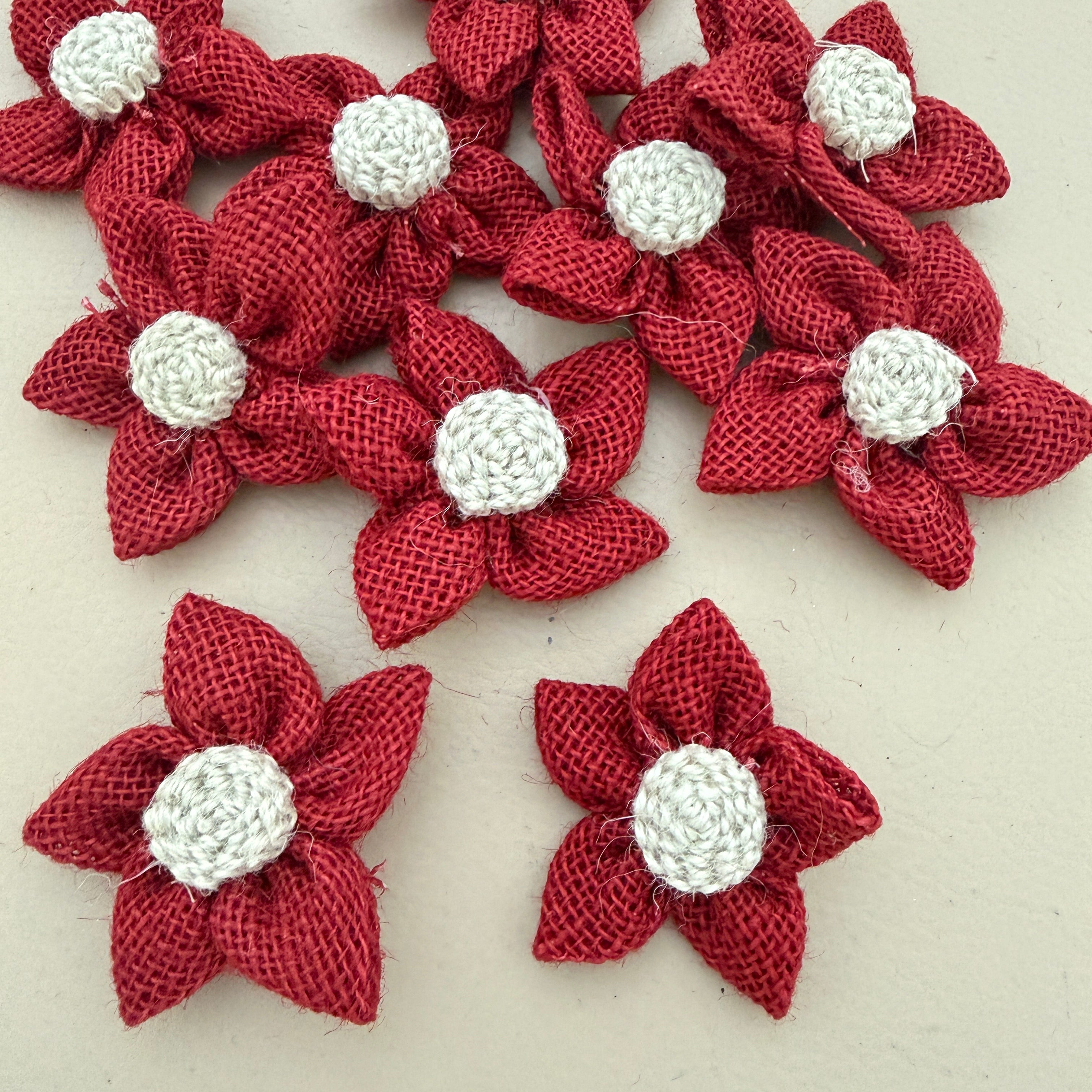 Pack of red jute burlap flower patches spread on beige background