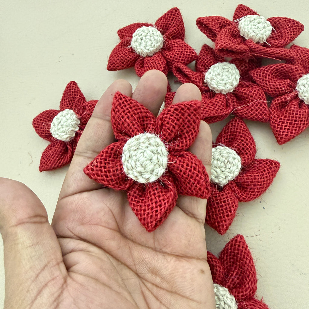 Red jute burlap flower patch held in hand showing size