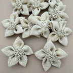 Pack of natural white jute burlap flower patches spread on grey background