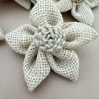 Close-up of natural white jute burlap flower patch showing rope rosette centre detail