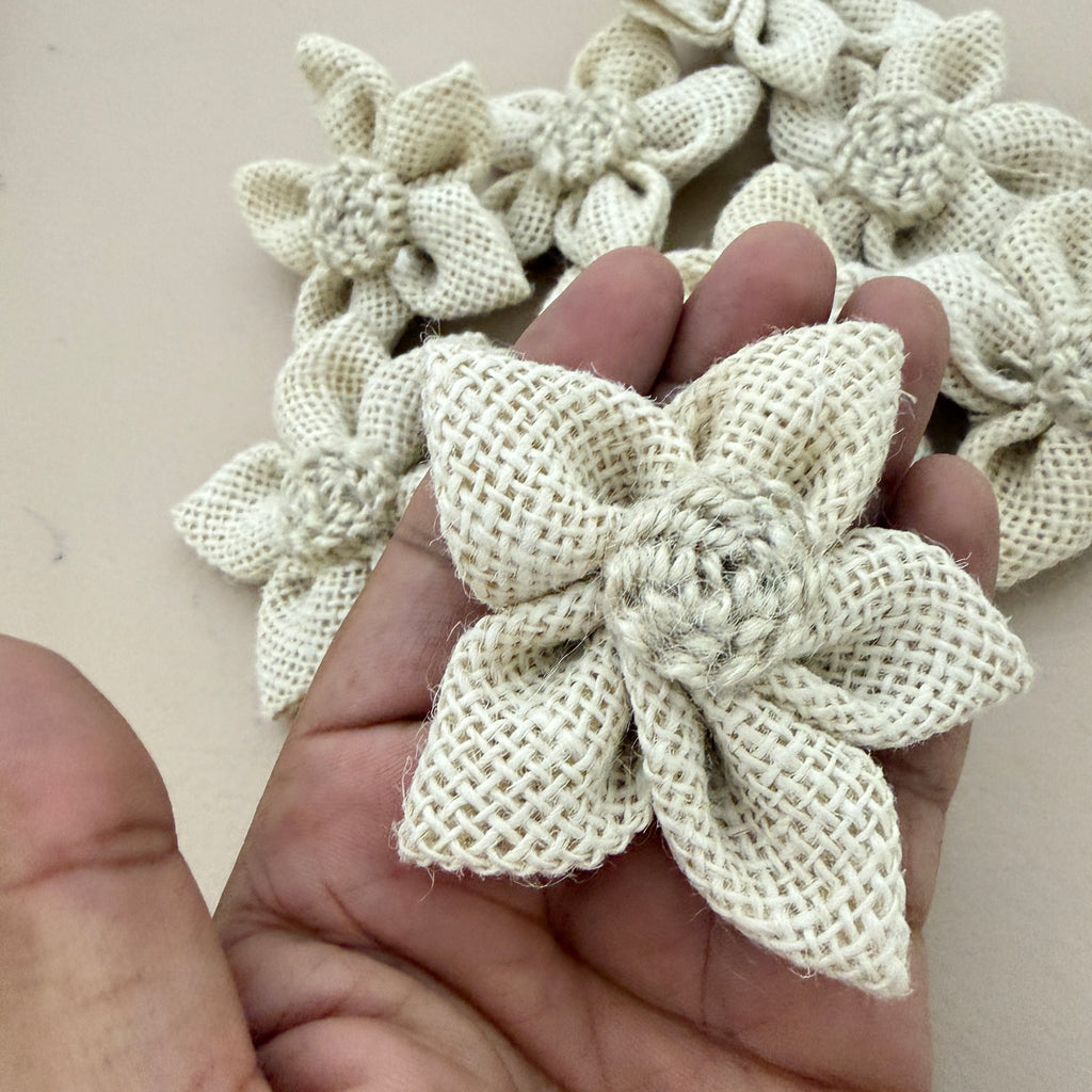 Natural white jute burlap flower patch held in hand showing size