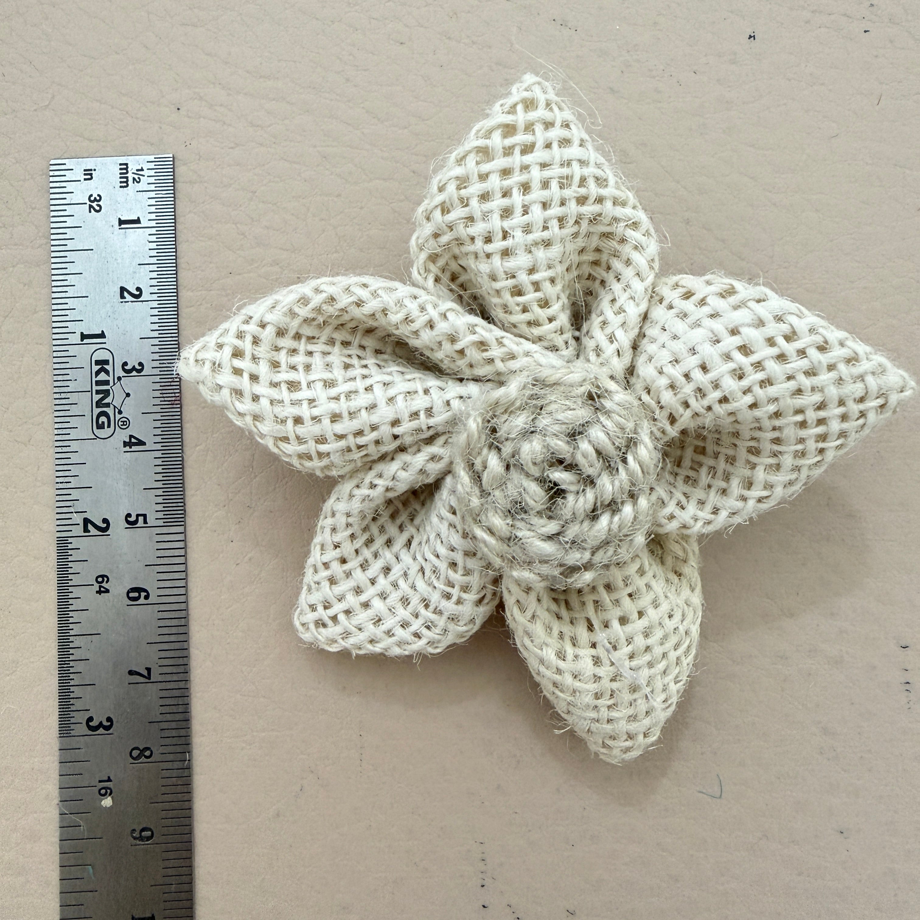Natural white jute burlap flower patch with ruler showing approx 7-8cm diameter