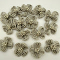 Pack of handmade jute twine flower patches spread on white background