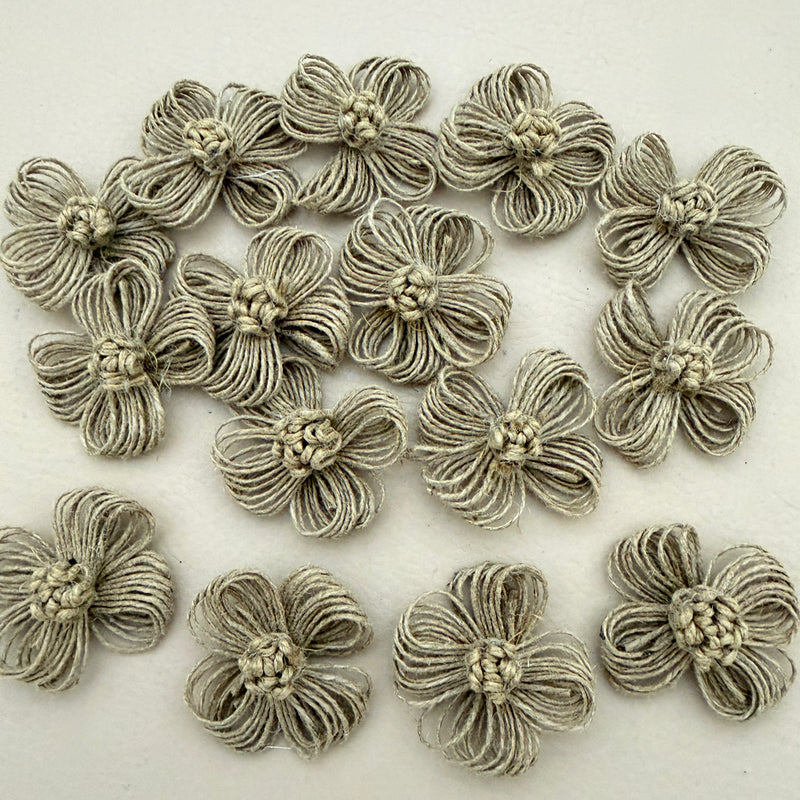 Pack of handmade jute twine flower patches spread on white background