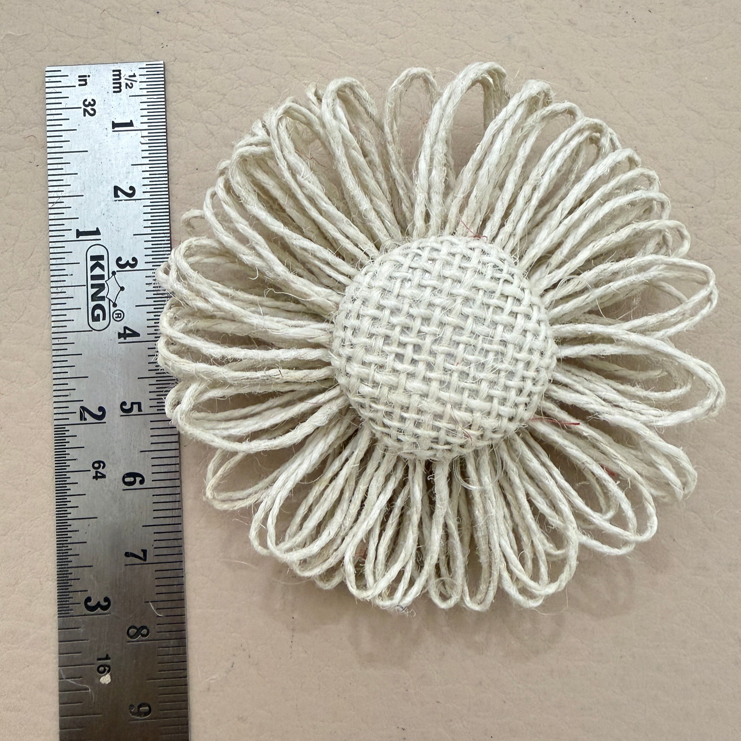 Jute twine daisy patch with ruler showing approx 7-8cm diameter