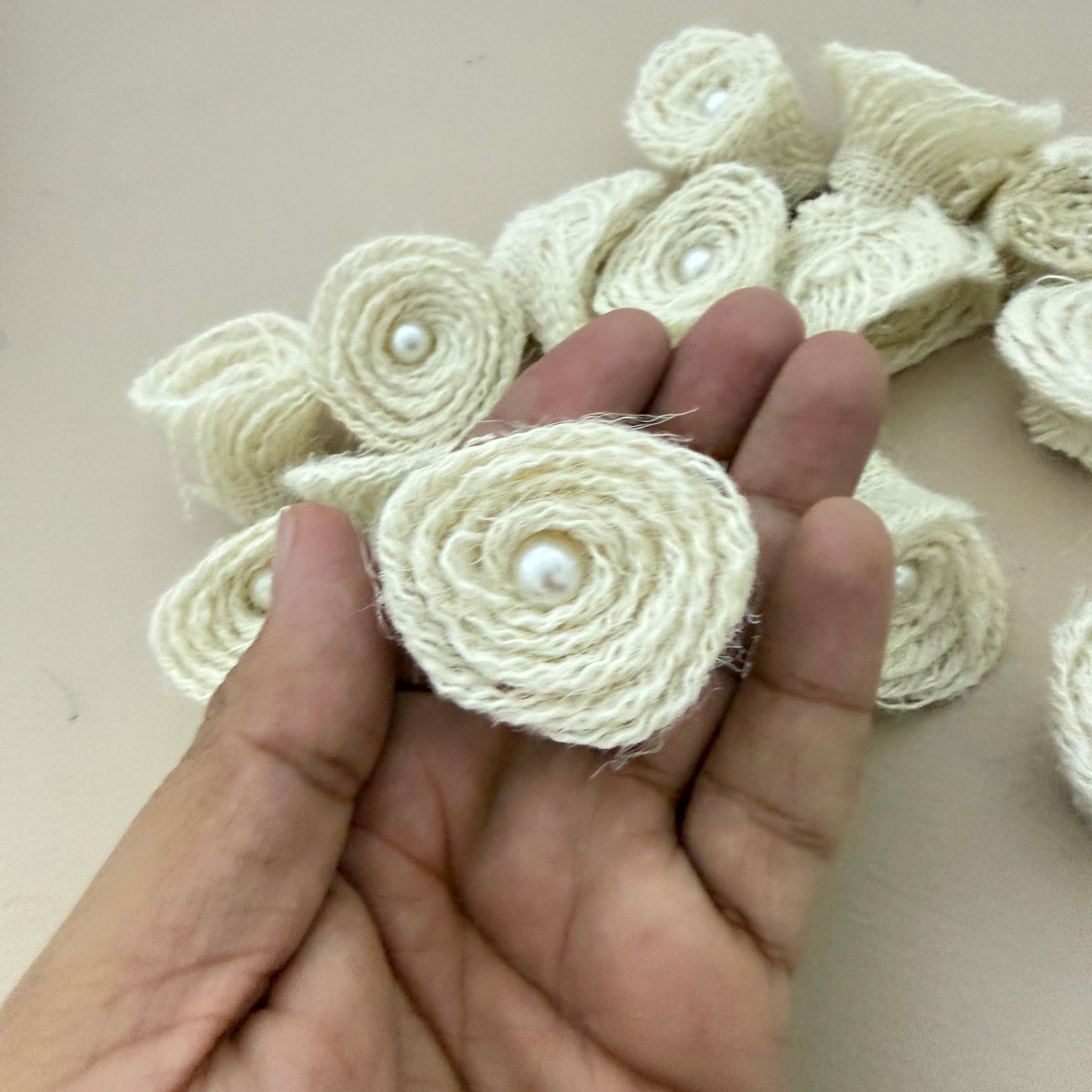 Jute rope rosette patch held in hand showing size and front detail