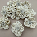 Pack of 3D puffed burlap flower patches spread on grey background