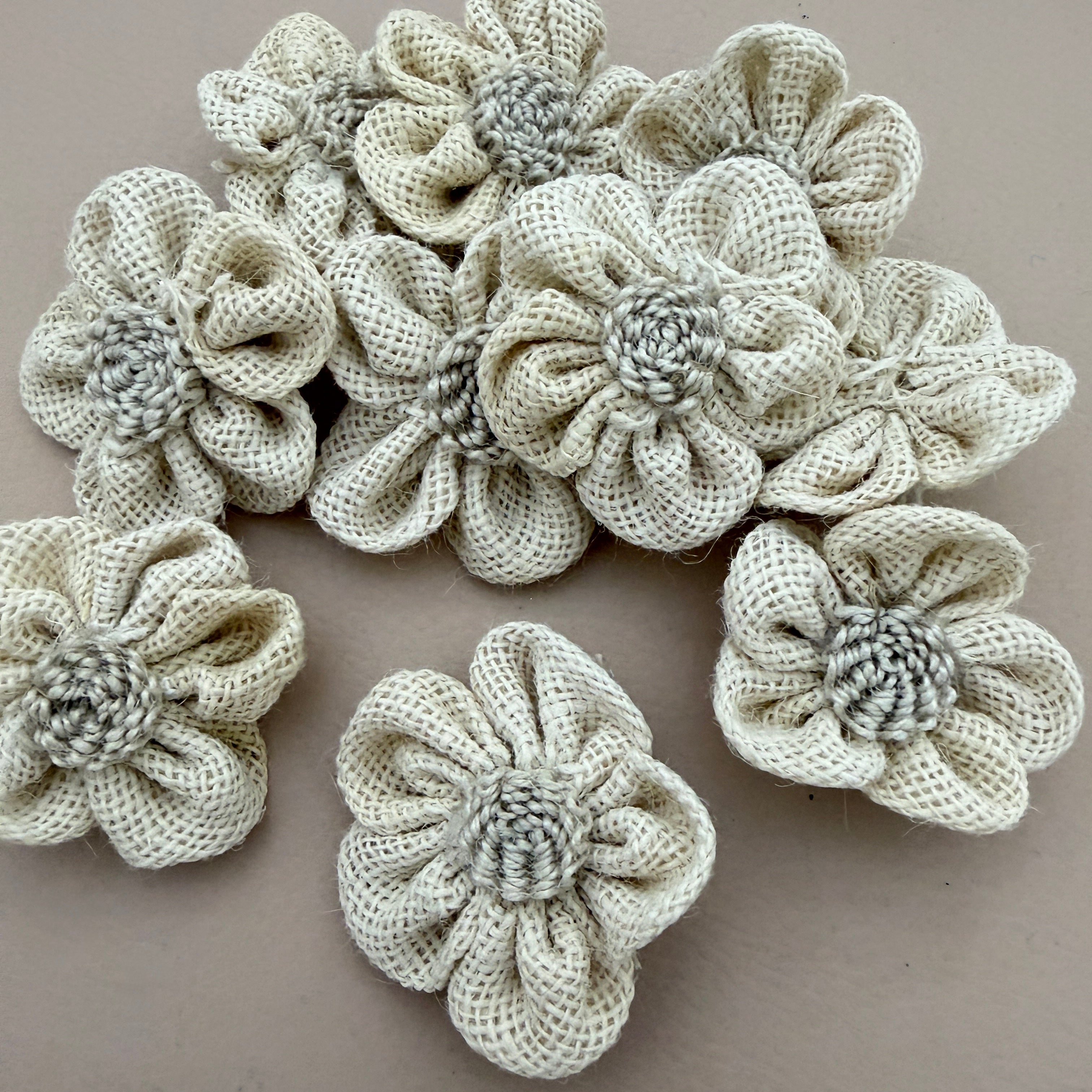 Pack of 3D puffed burlap flower patches spread on grey background