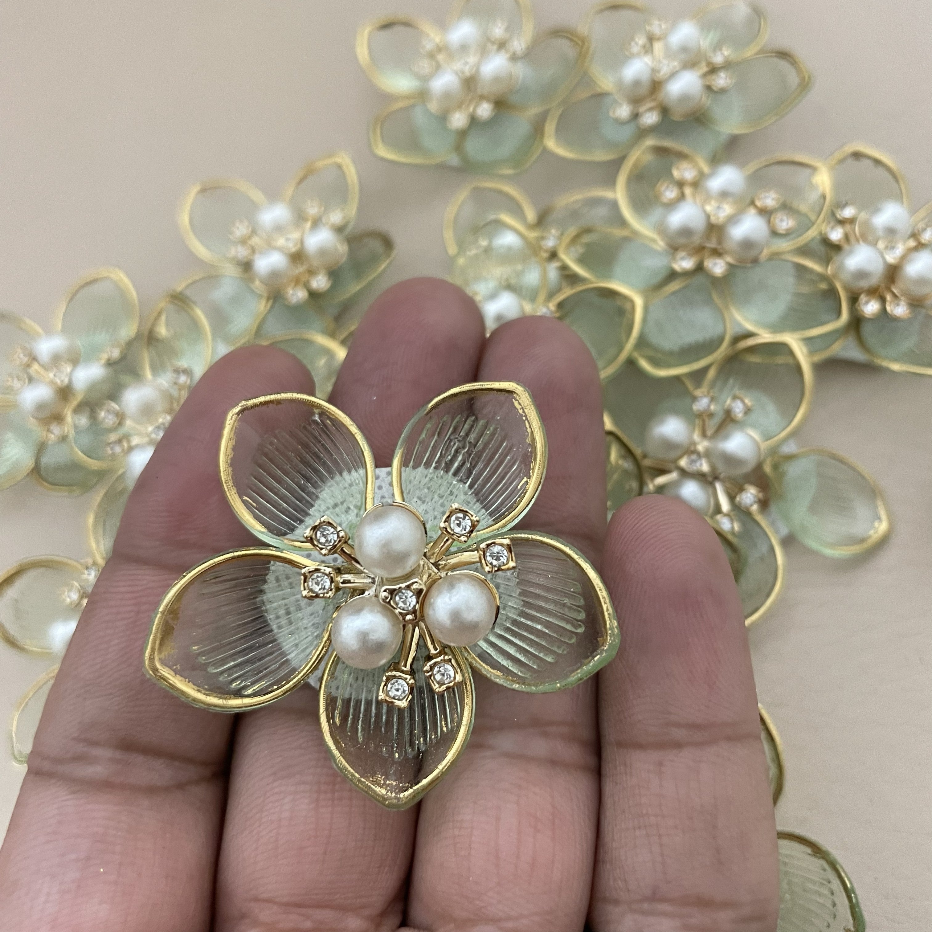 Mint green pearl flower patches with ruler for size reference