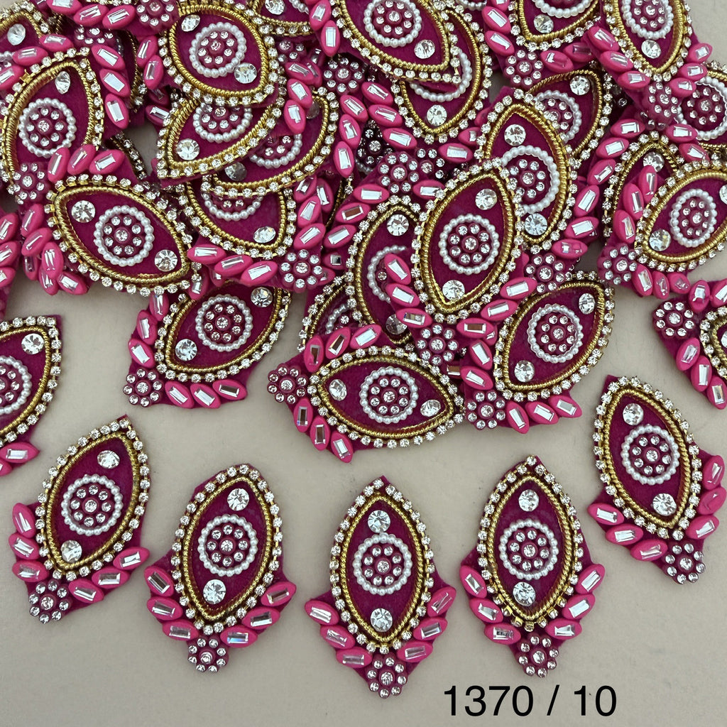 Rani pink rhinestone oval patch held in hand for scale