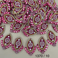 Rani pink rhinestone oval patch held in hand for scale