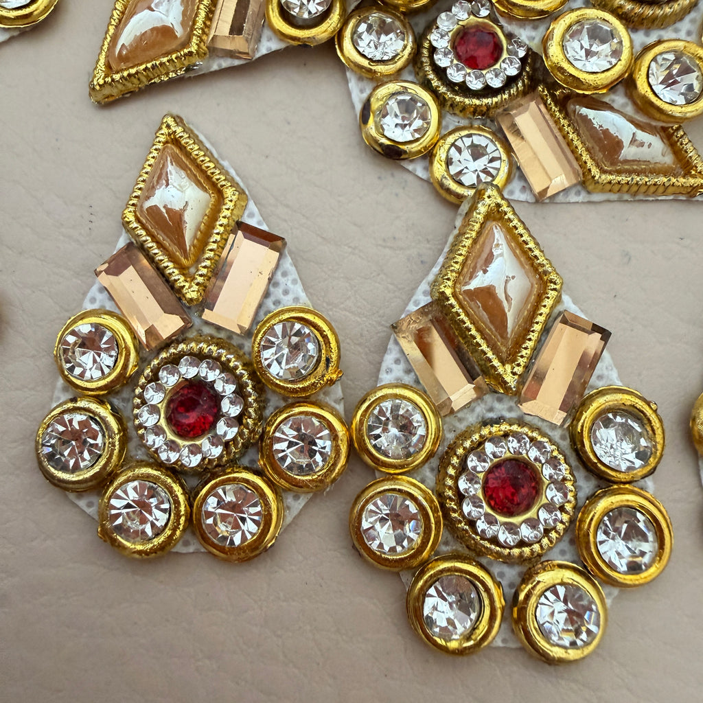Two gold rhinestone patches side by side showing front detail