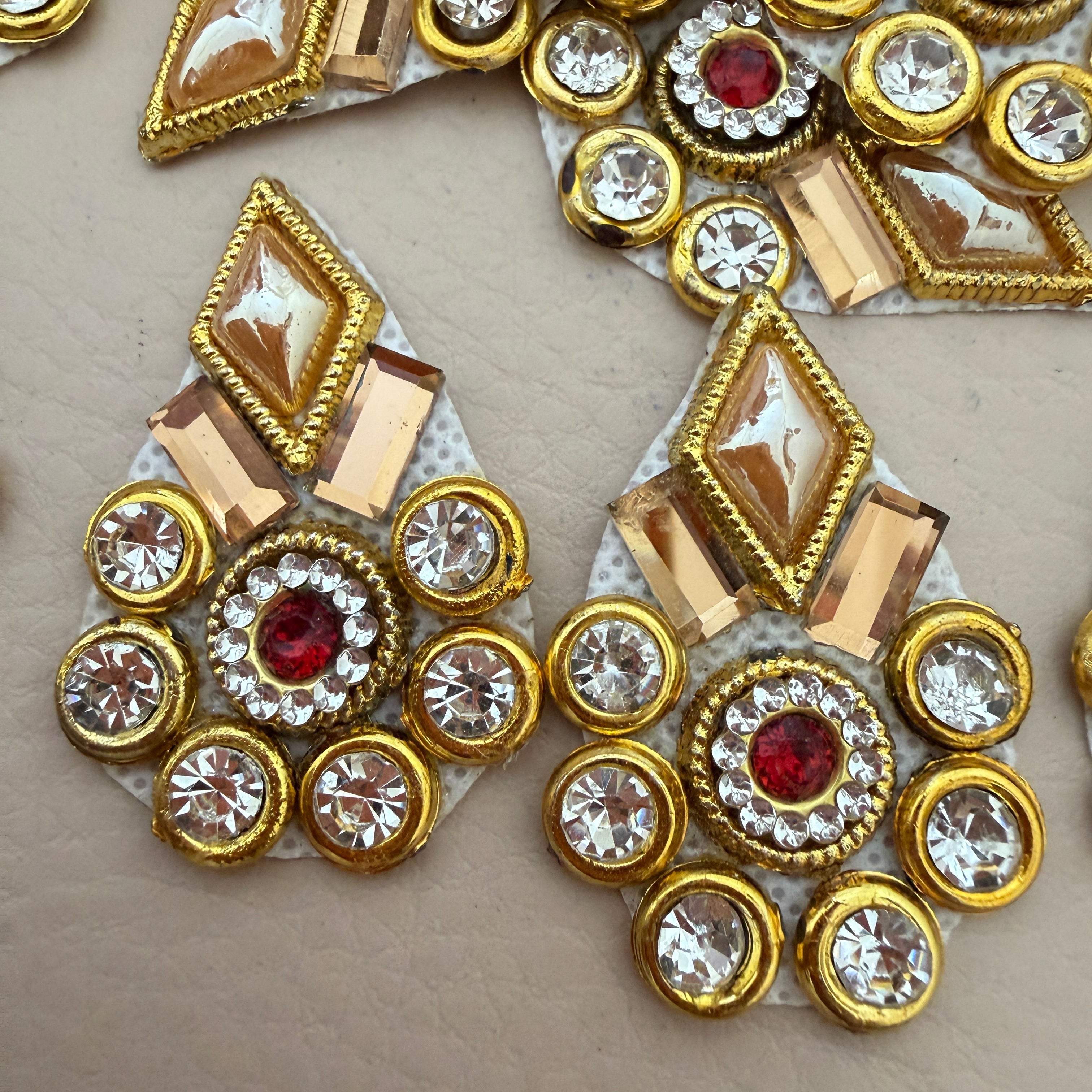 Two gold rhinestone patches side by side showing front detail