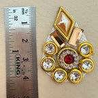 Hand holding a gold rhinestone patch to show size