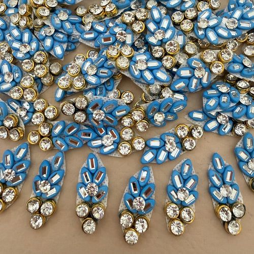 Front and back view of blue rhinestone leaf patch showing mesh backing