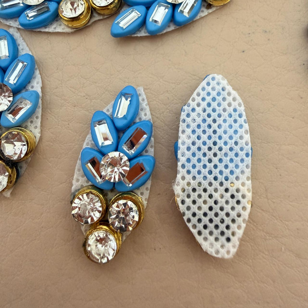 Blue rhinestone leaf patch with ruler for size reference