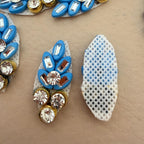 Blue rhinestone leaf patch with ruler for size reference