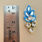 Close-up of multiple blue rhinestone leaf patches showing detail