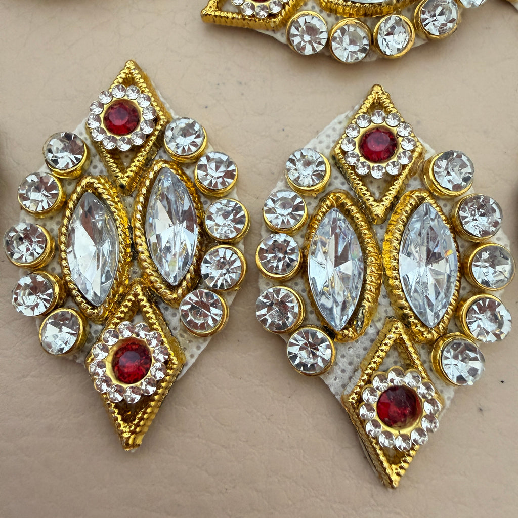 Hand holding a gold diamond rhinestone patch to show size