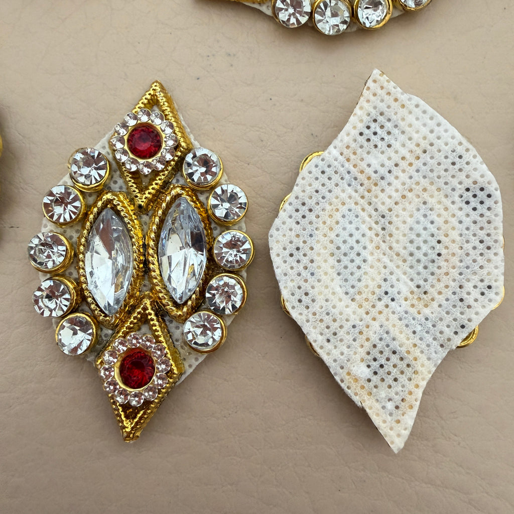 Two gold diamond rhinestone patches side by side showing front detail