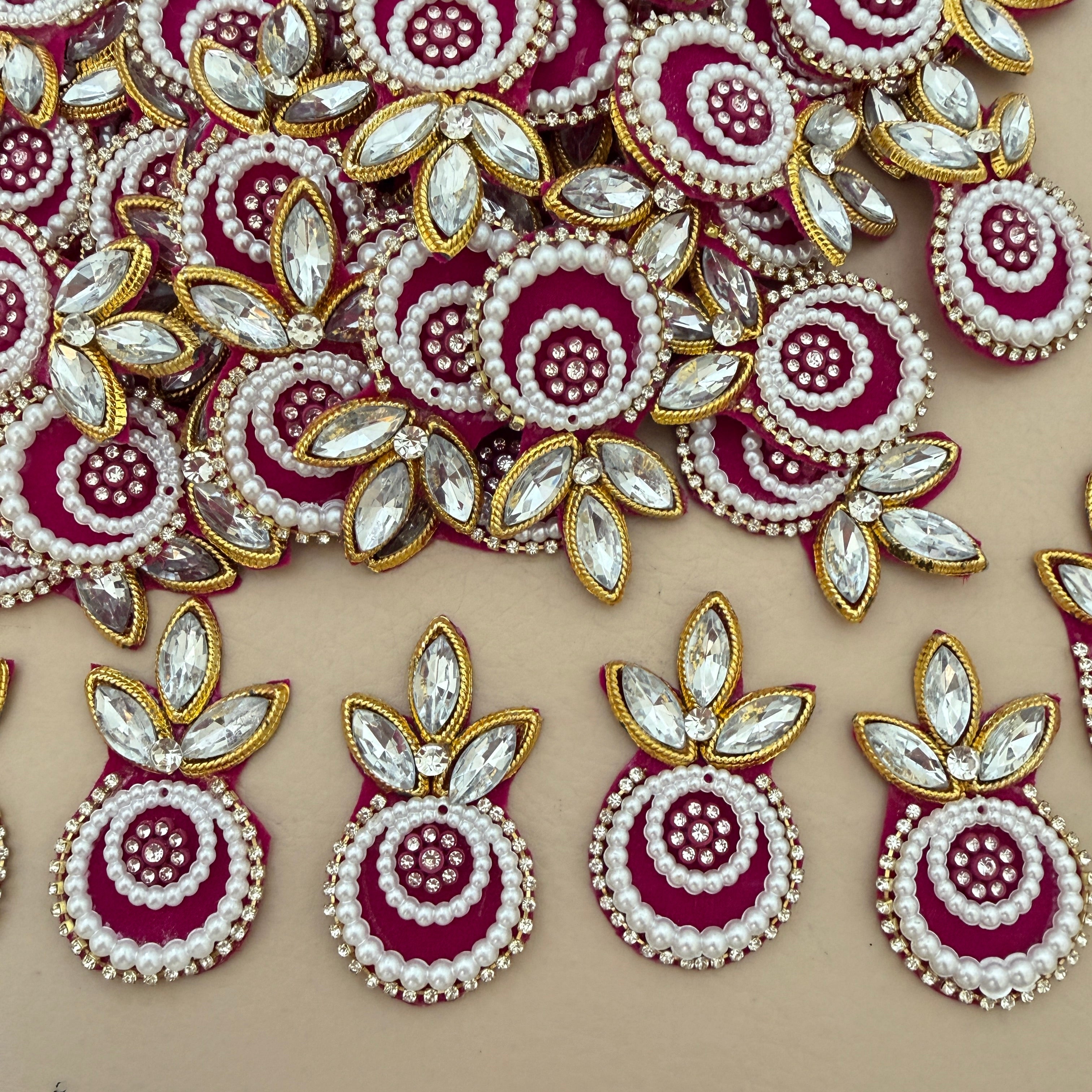 Maroon pearl crystal patch held in hand – front view