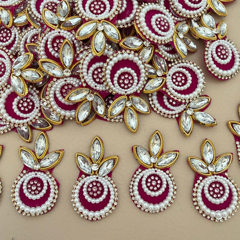 Maroon pearl crystal patch held in hand – front view