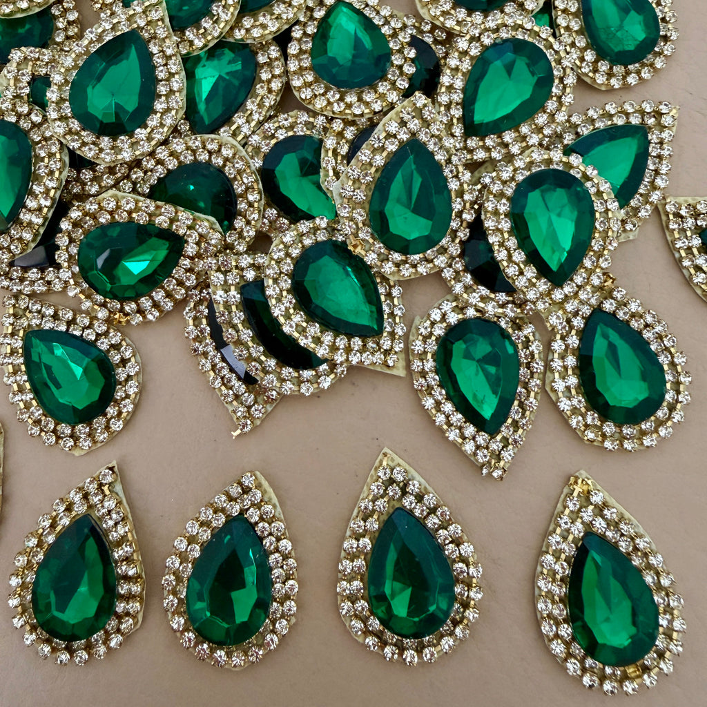 Emerald green teardrop rhinestone patches arranged in a circle – top view