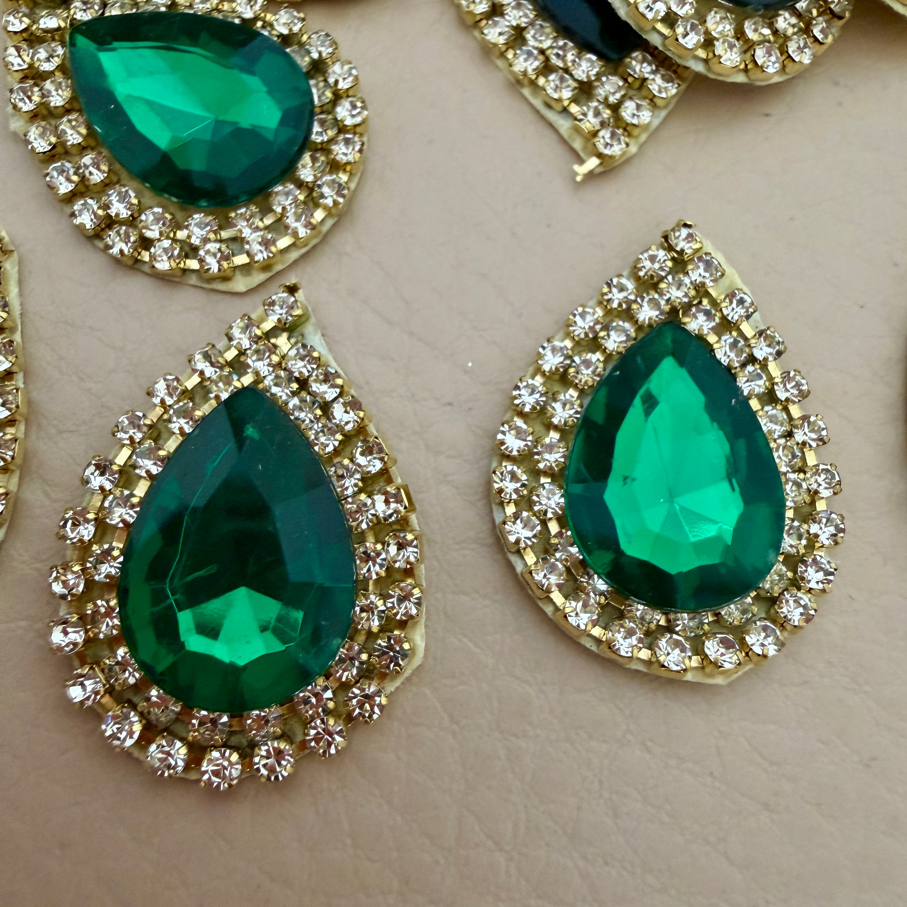 Close-up of two emerald green teardrop patches showing detail