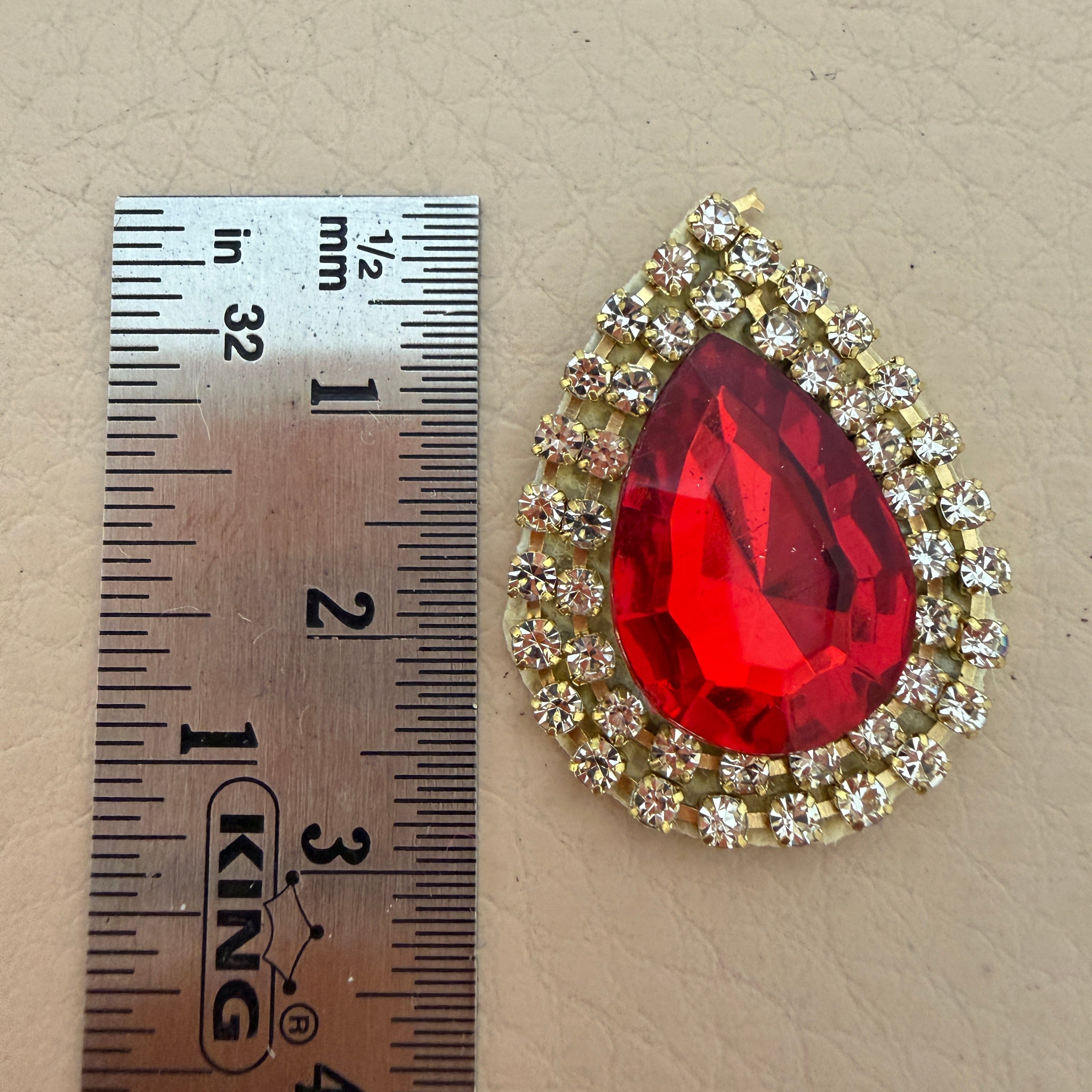 Single red teardrop patch with ruler – approx 3.5cm size reference