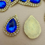 Front and back view of royal blue teardrop patch showing net mesh backing