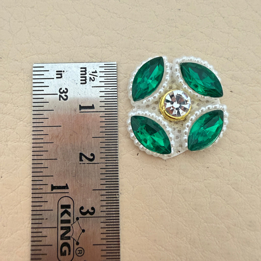 Emerald green rhinestone flower patch with ruler showing approx 3cm diameter