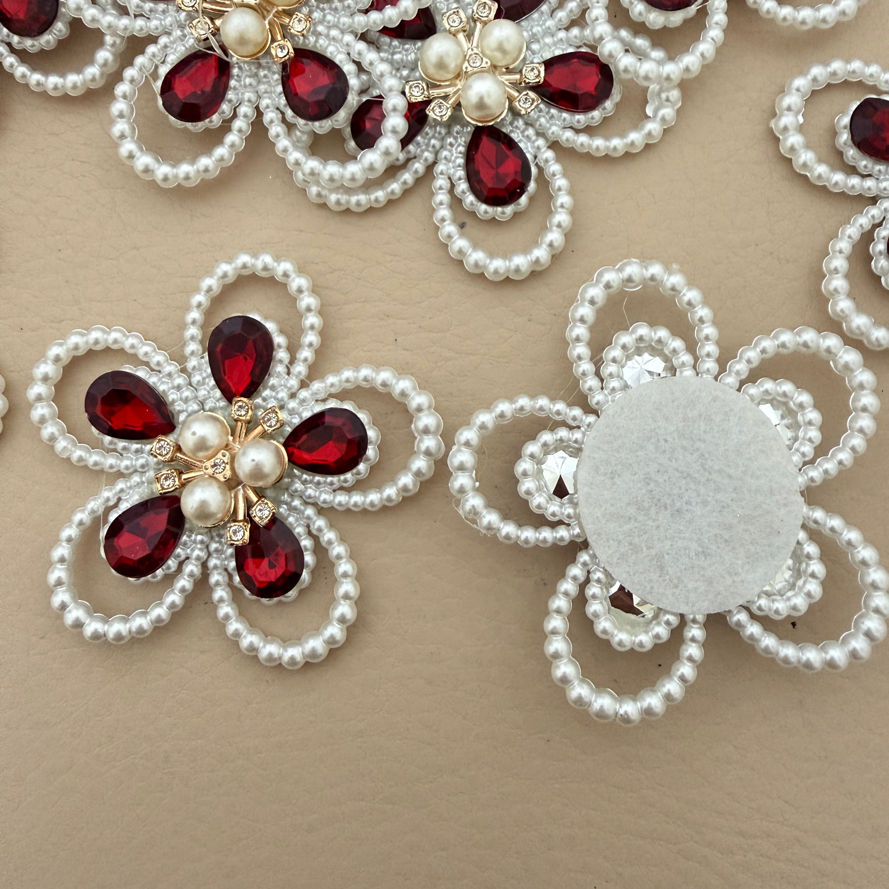 Red crystal pearl flower patch with ruler for size reference