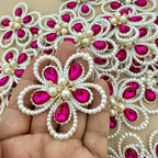Fuchsia crystal pearl flower patch held in hand showing scale against bulk lot