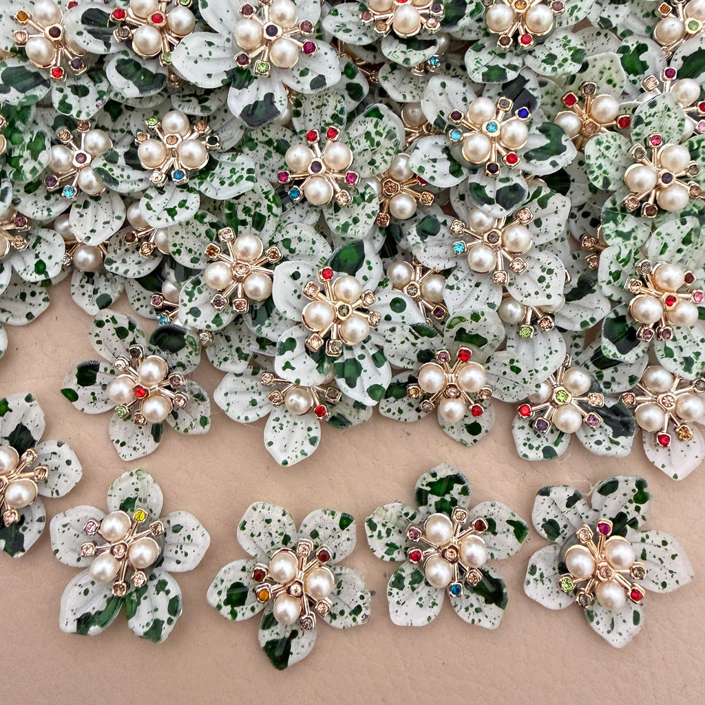 Green speckle pearl rhinestone flower patches – bulk lot overhead view