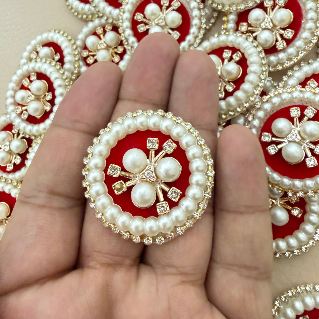 Red velvet pearl rhinestone round patch held in hand showing scale against bulk lot