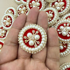 Red velvet pearl rhinestone round patch held in hand showing scale against bulk lot
