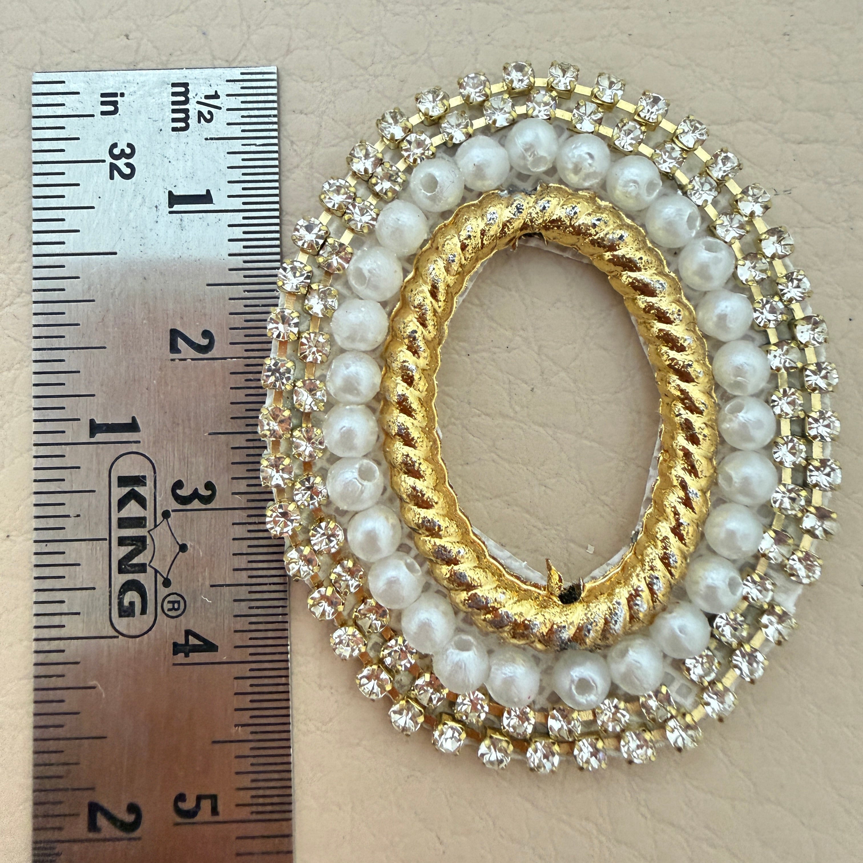 Close-up detail of pearl beads and rhinestone cup chain