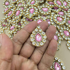 Pink rhinestone crystal patch held in hand showing scale