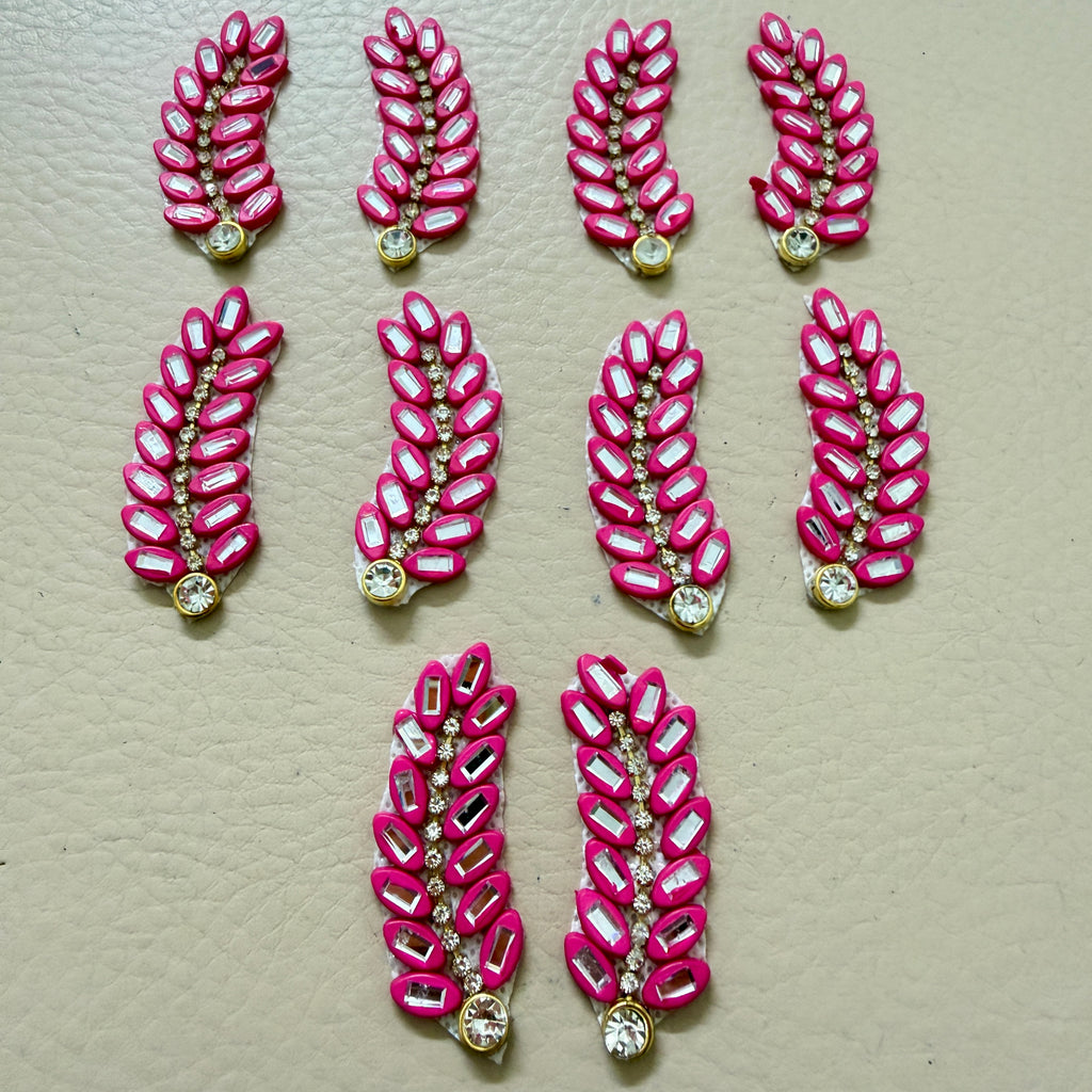 Bulk lot of hot pink rhinestone leaf motif patches spread out