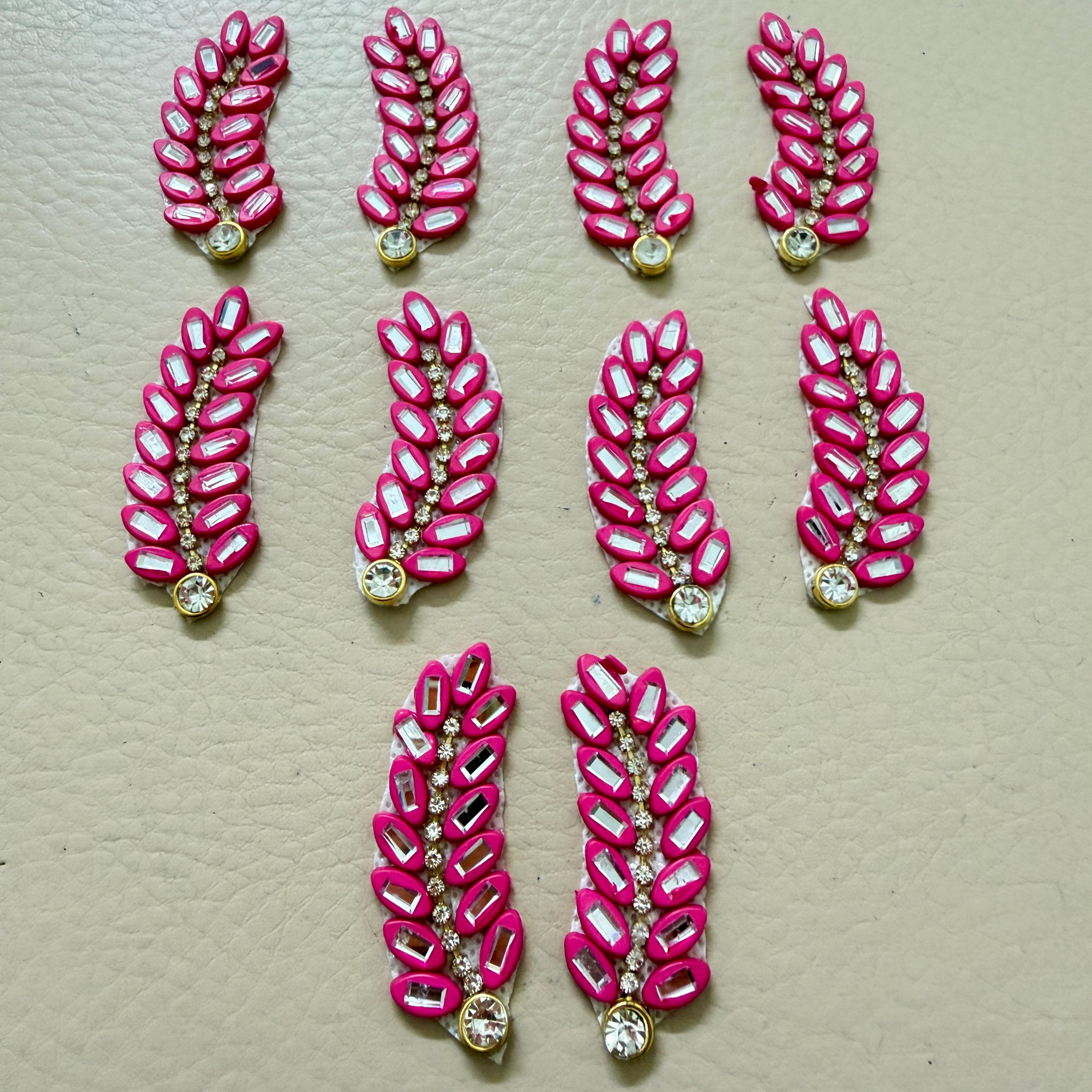 Bulk lot of hot pink rhinestone leaf motif patches spread out