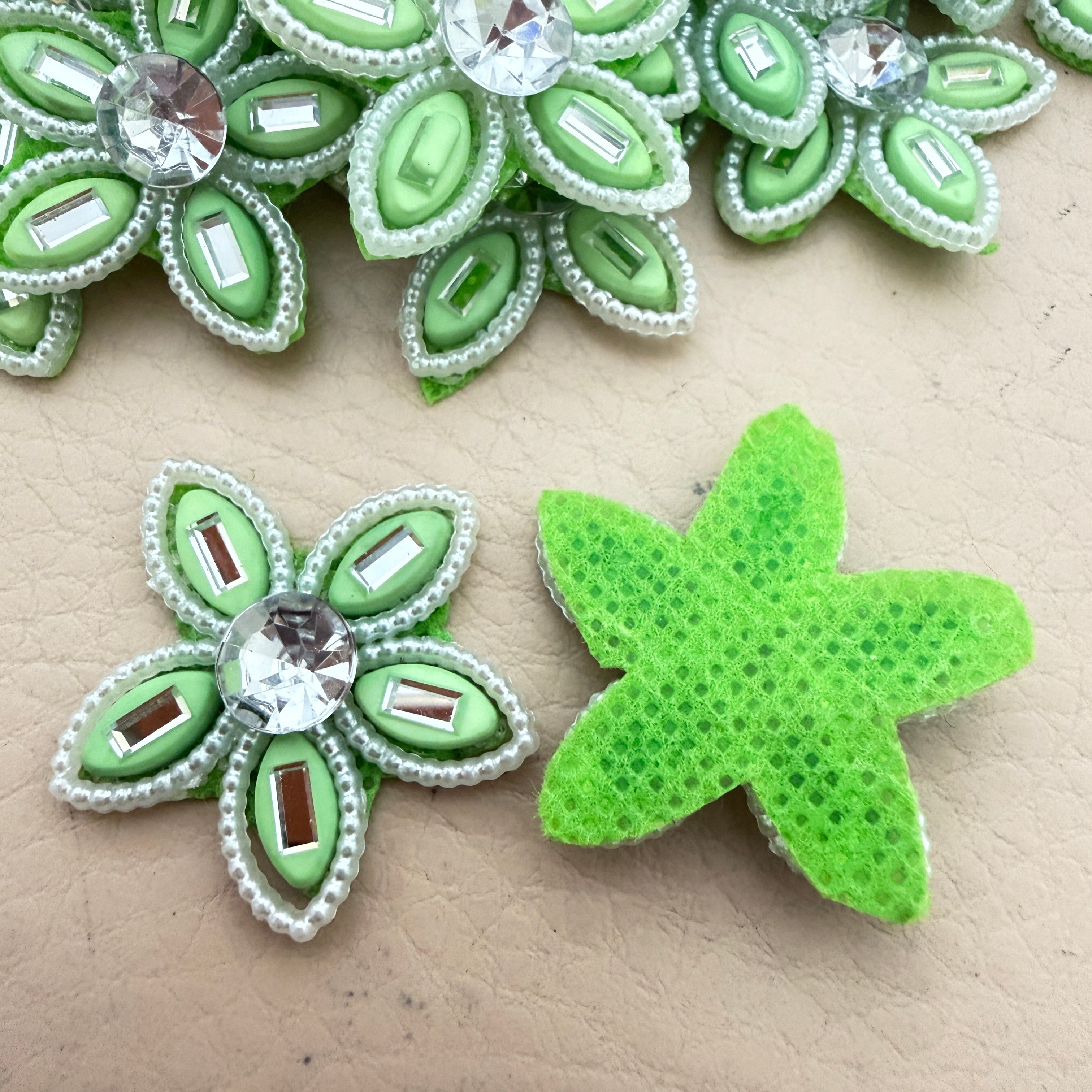 Front and back view of mint green rhinestone flower motif patch showing foam base