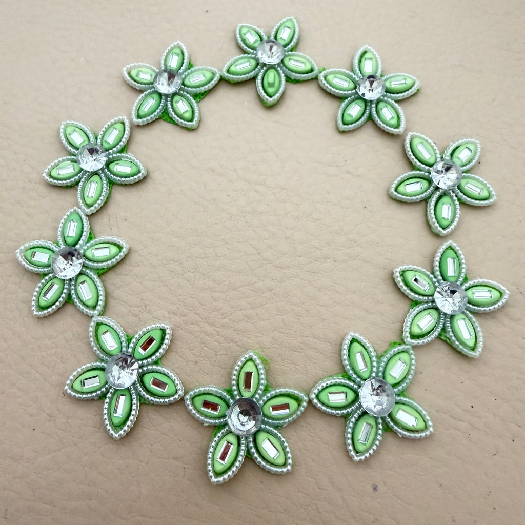 25 mint green rhinestone flower motif patches arranged in a circle