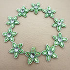 25 mint green rhinestone flower motif patches arranged in a circle