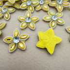 Front and back view of yellow rhinestone star flower motif patch showing foam base