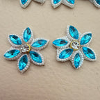 Two aqua blue marquise rhinestone star flower motif patches showing front detail up close