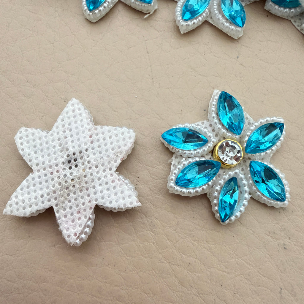 Front and back view of aqua blue rhinestone star flower motif patch showing foam base