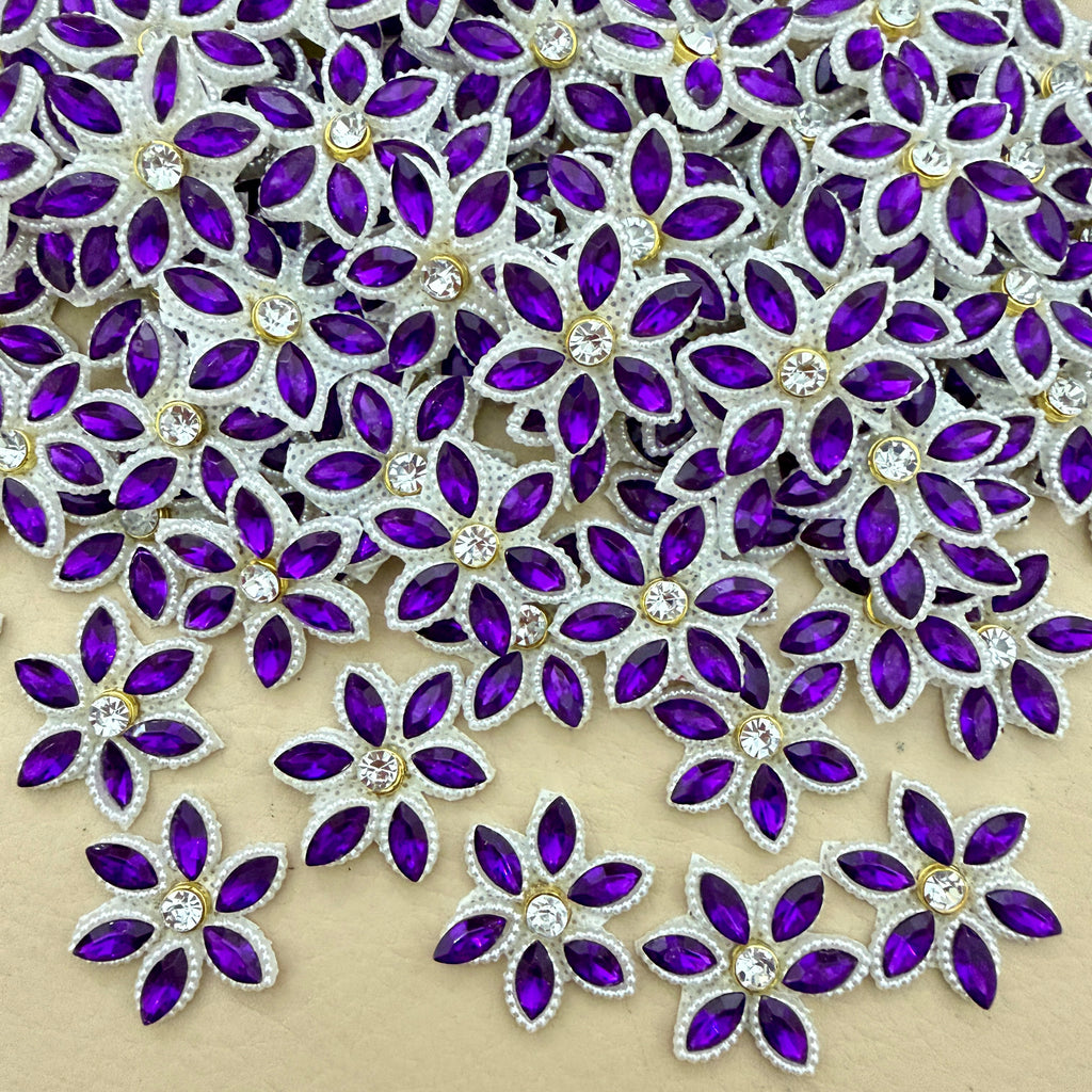 Bulk lot of purple marquise rhinestone star flower motif patches spread out on surface